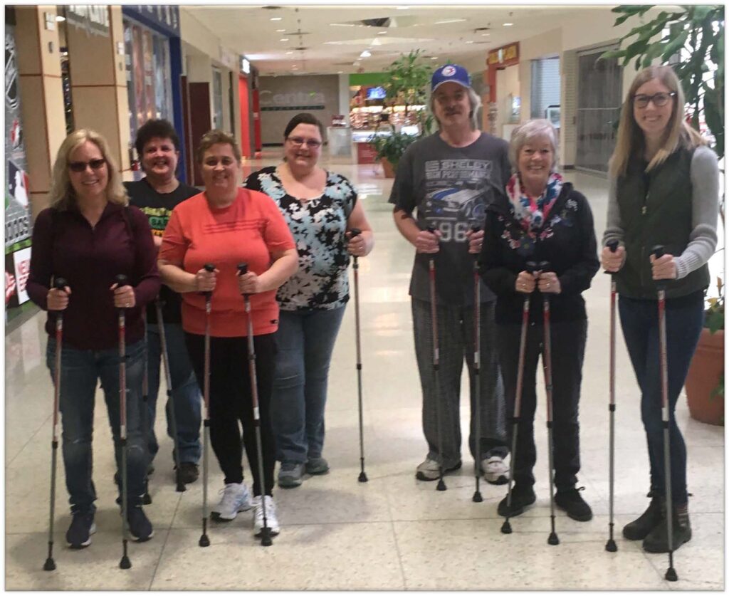 Participants in the 8-week Urban Poling program standing together with their poles.